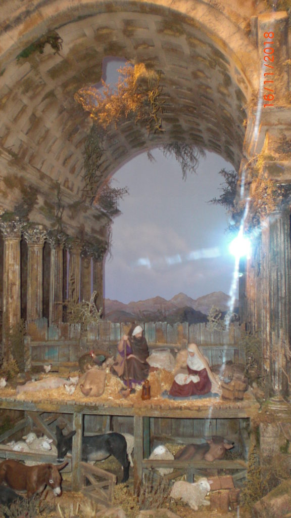 a lovely nativity situated in a ruin with archway