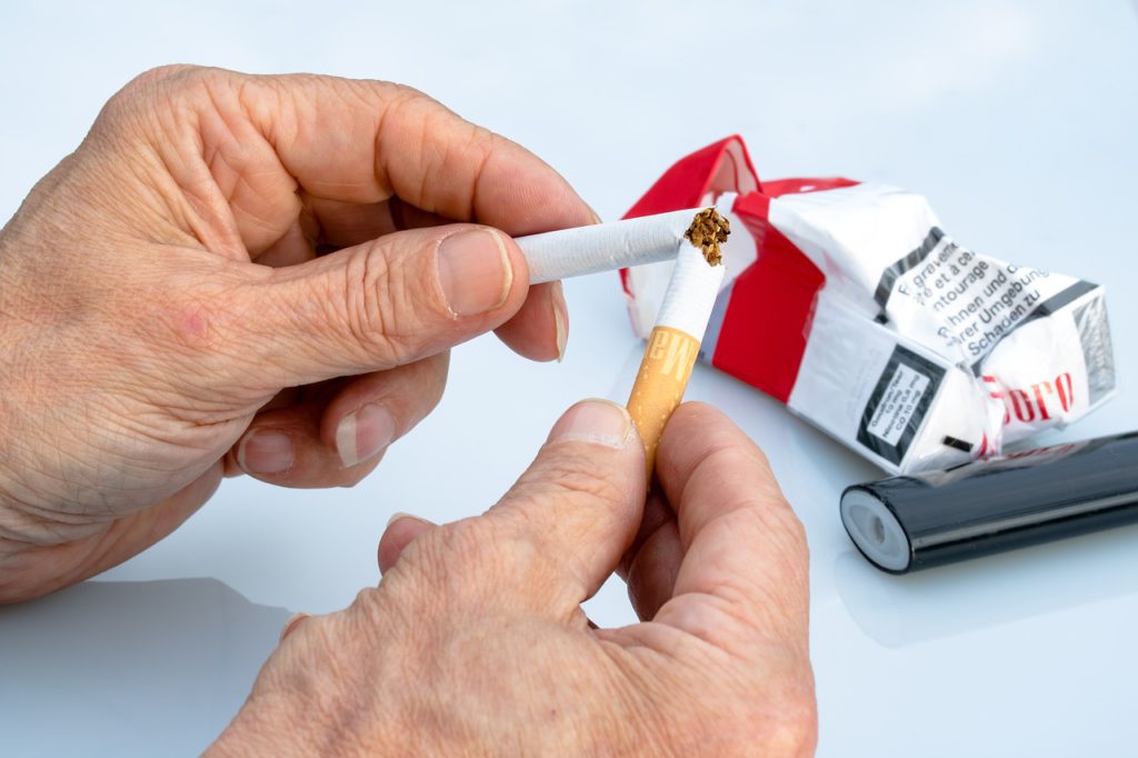 somebody breaking a cigarette
