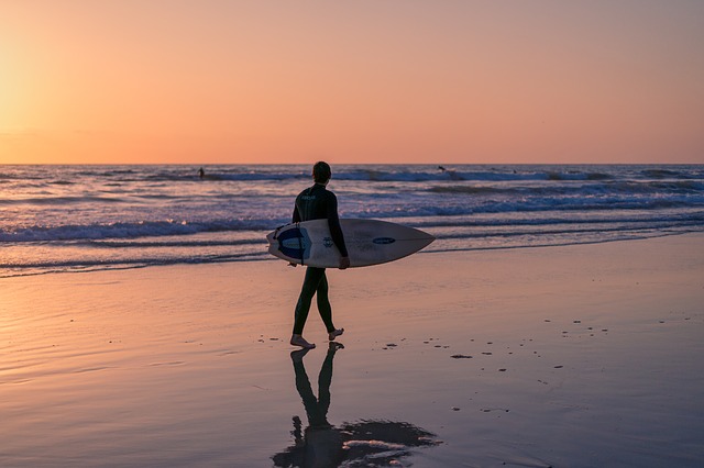 Surfer walking on beach
